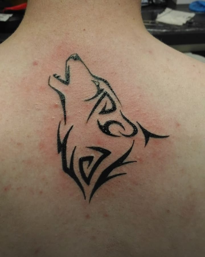 Wolf tattoo on a neck