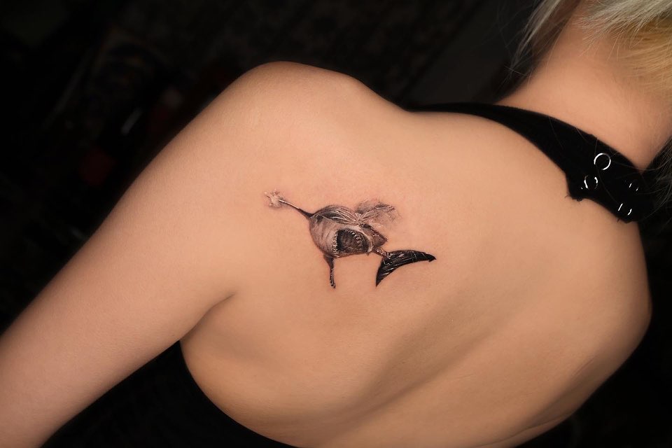 A tattoo of a shark that is in danger