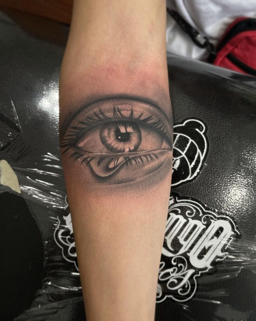 Sketchy realistic eye tattoo on arm