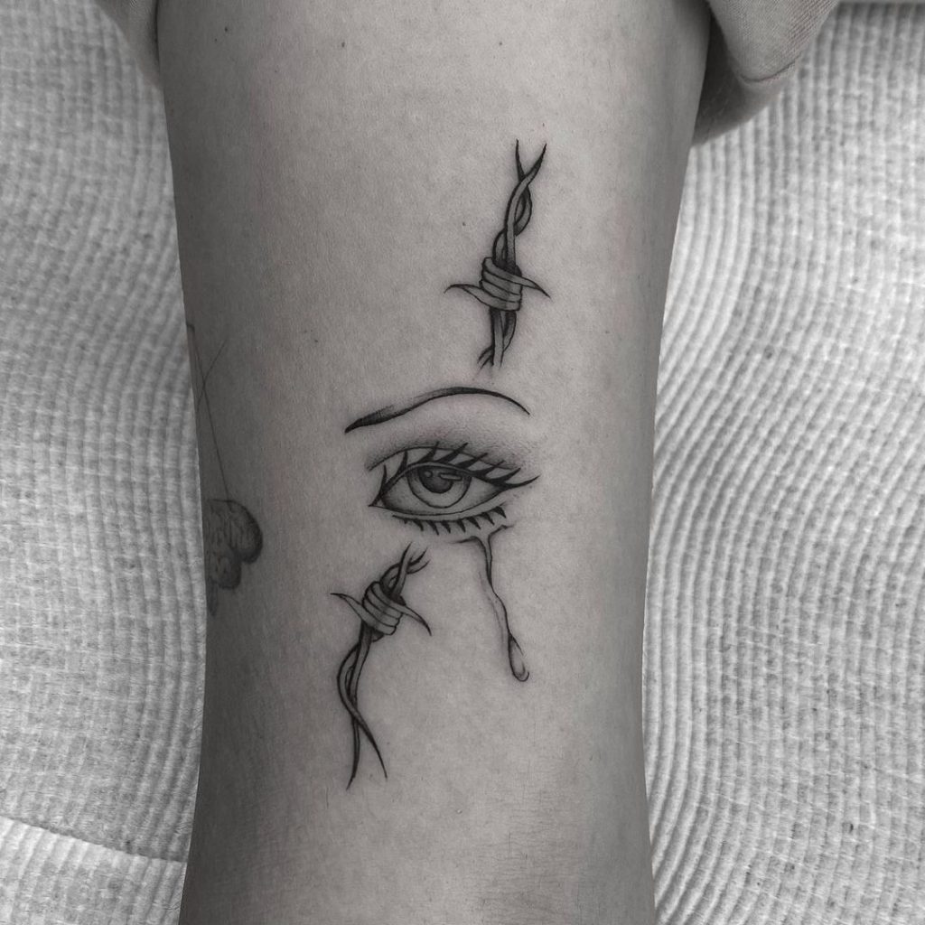 Realistic eye tattoo with strings around
