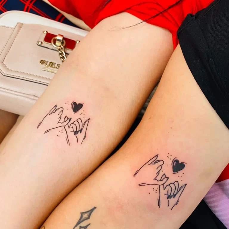 pinky holding sister tattoo